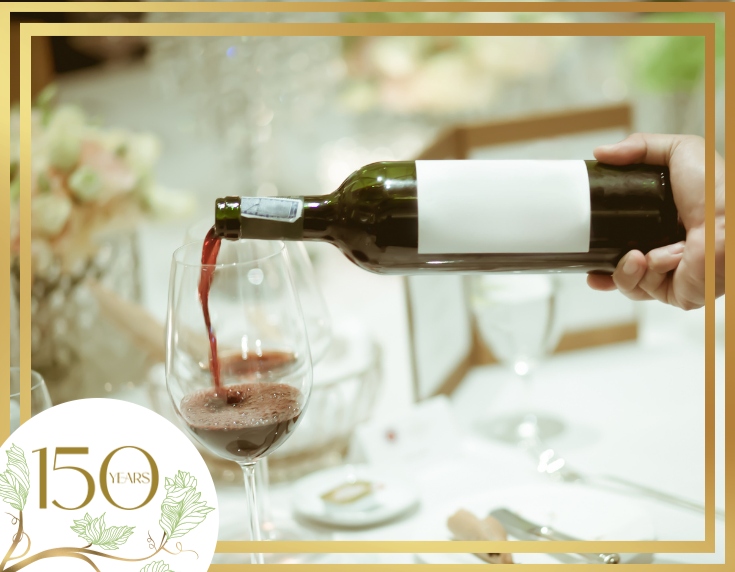 Red wine being poured into glass on table