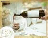Red wine being poured into glass on table view 3
