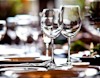 Wine glasses in foreground on dining table