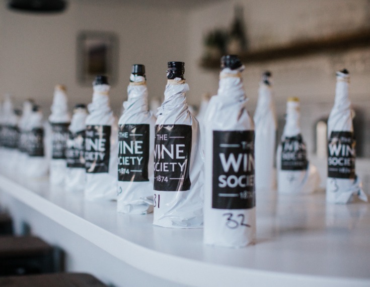 Wine bottles in branded blind tasting bags