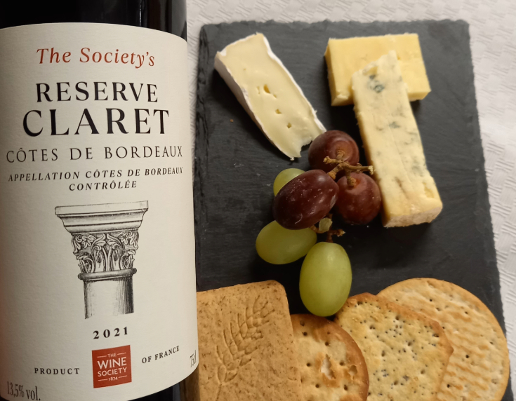 Close up of wine bottle and cheese platter