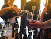Red wine being poured in outheld glass